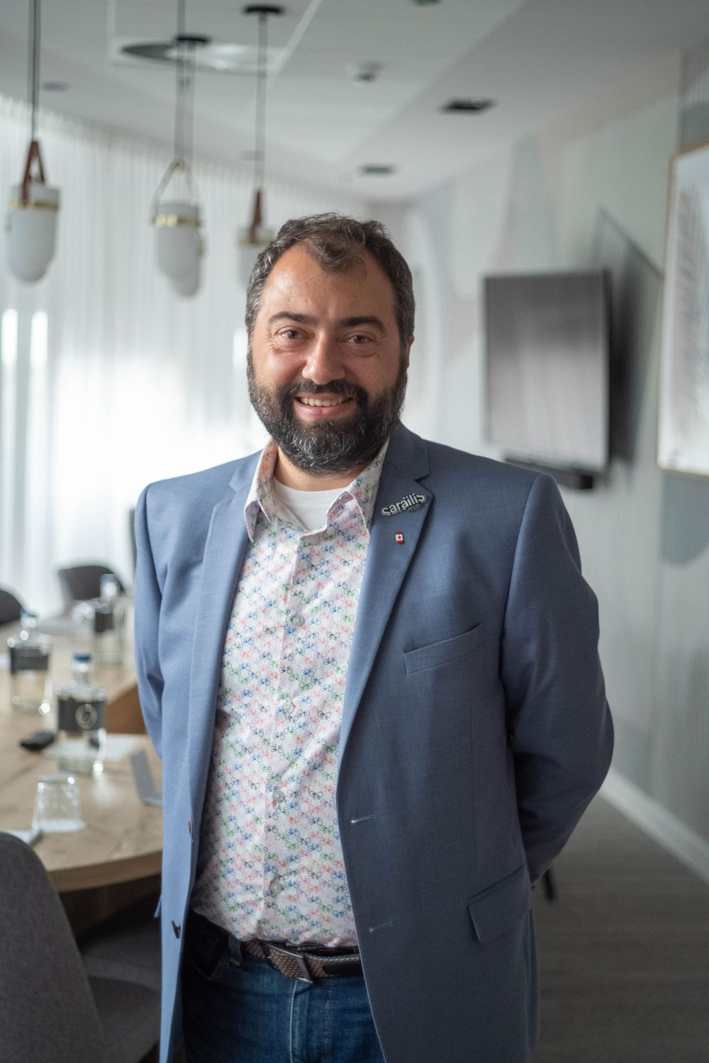 Christian Sarailis standing in a boardroom