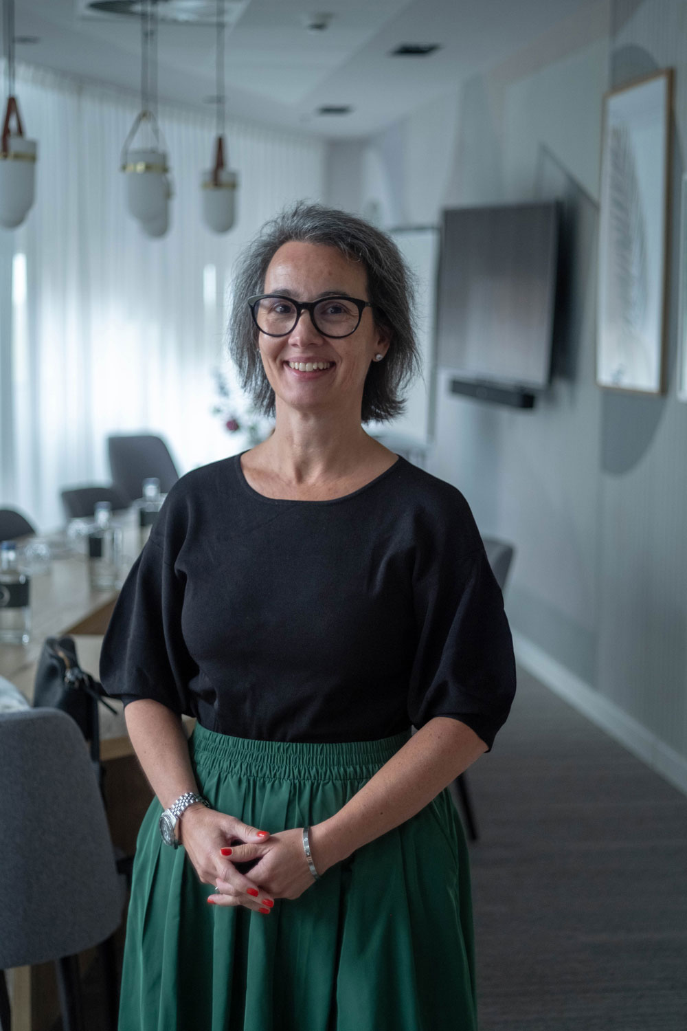 Ana Rita standing in a boardroom